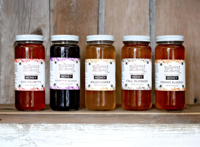 Jars of honey with the Beekeeper's Daughter label