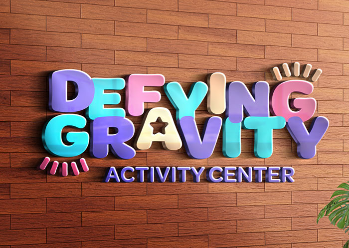 The Defying Gravity logo shown as indoor wall signage.