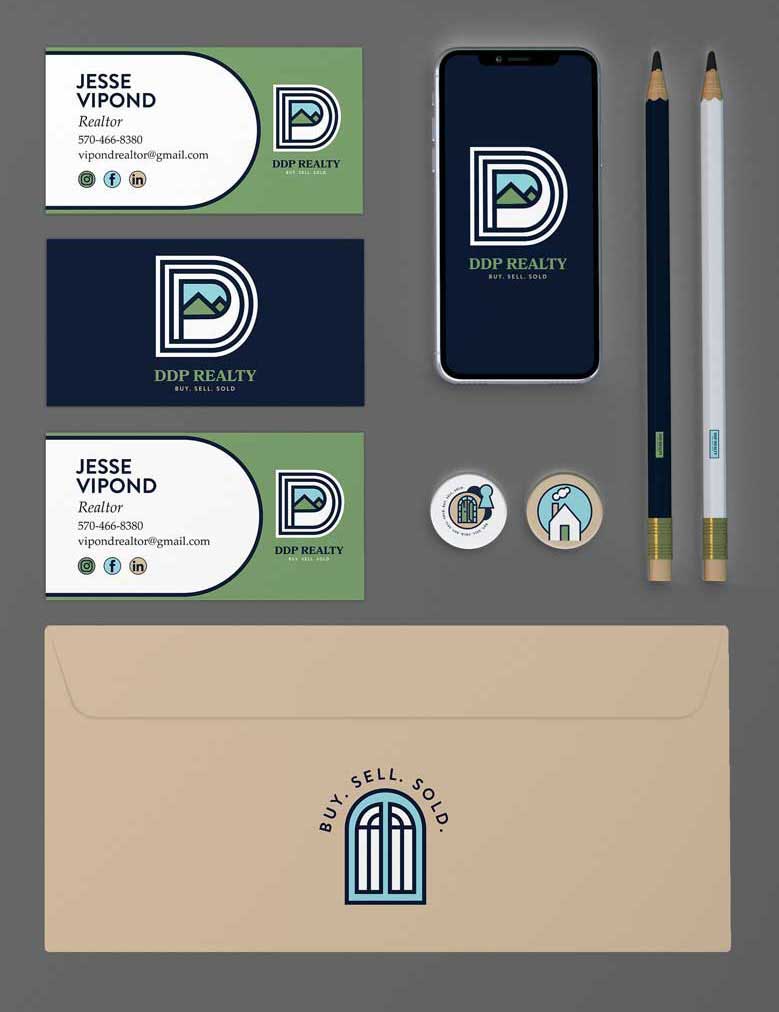 The DDP Realty Branding shown on business cards, pencils, and envelopes.